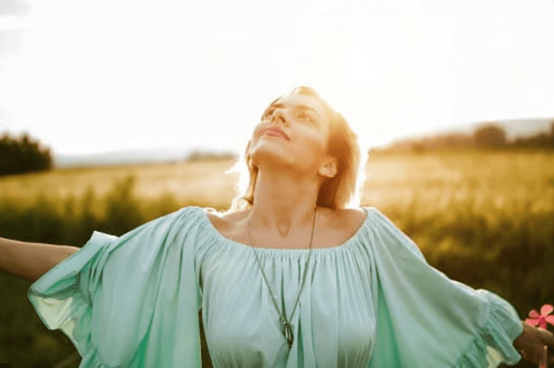 Confident midlife woman practicing self-care in a calm, natural setting