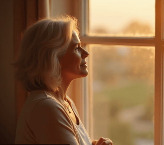 A mature woman gazed out a window