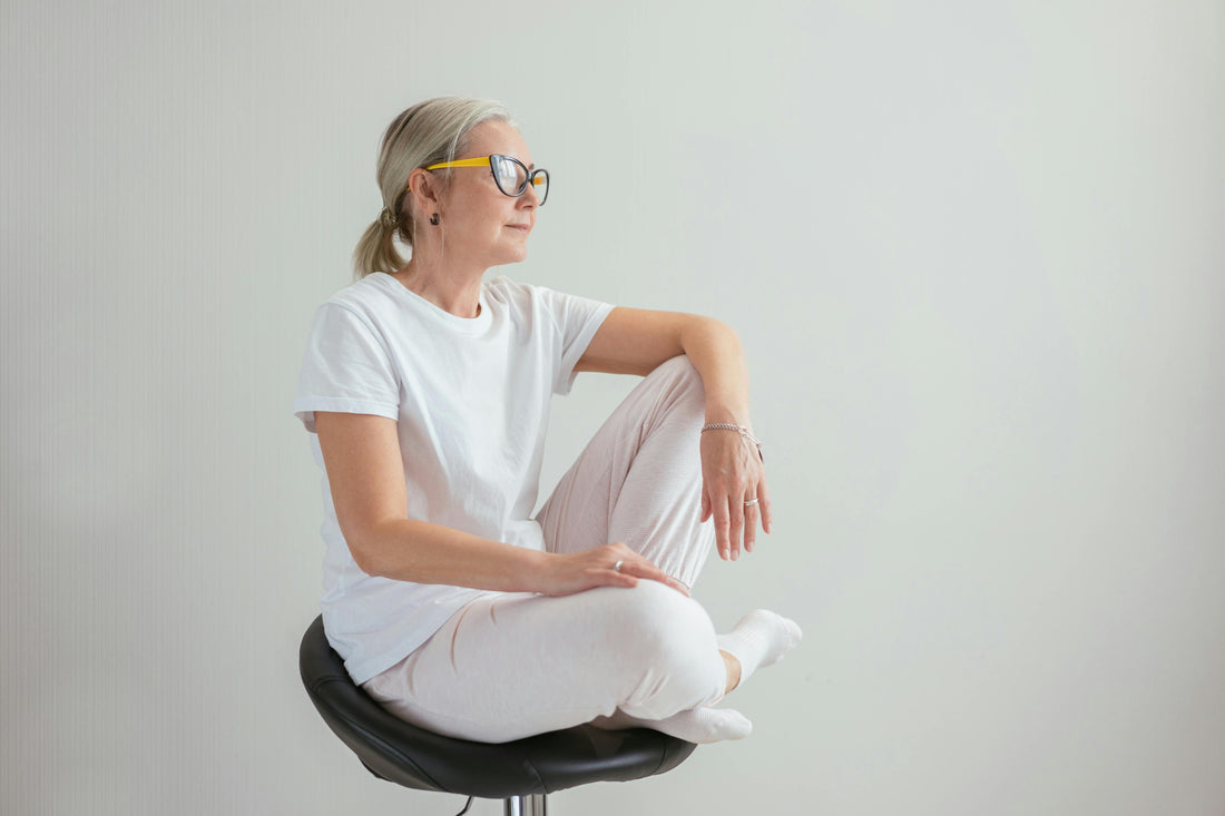 Woman in her 40s sitting quietly and reflectively, representing changes in desire and intimacy during perimenopause
