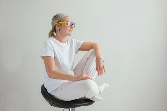 Woman in her 40s sitting quietly and reflectively, representing changes in desire and intimacy during perimenopause